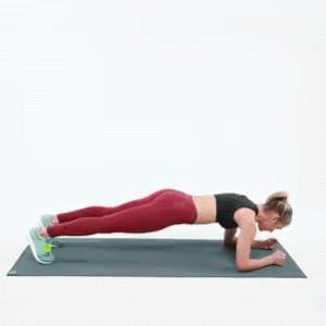 a woman in a blue shirt and purple pants does planks on her stomach