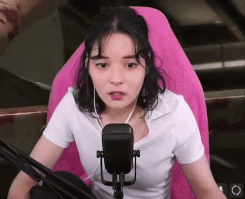 an asian girl on the radio while holding a microphone