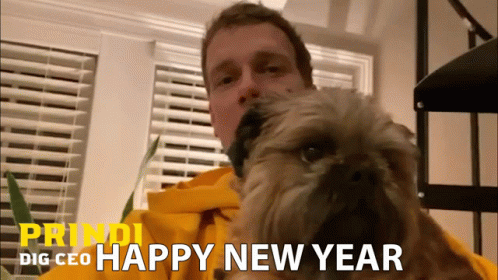 the man is holding his dog while he has a new year message