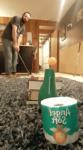 a man using a mop to clean carpet in an office