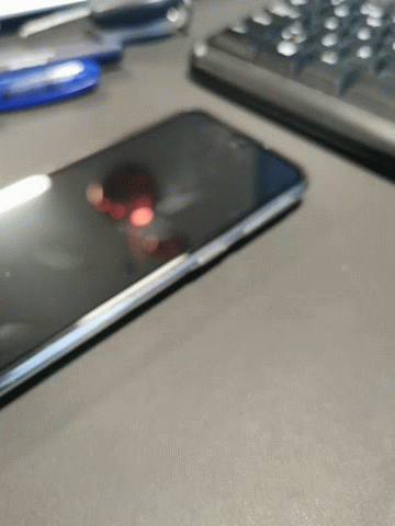a phone sitting on a table next to a keyboard