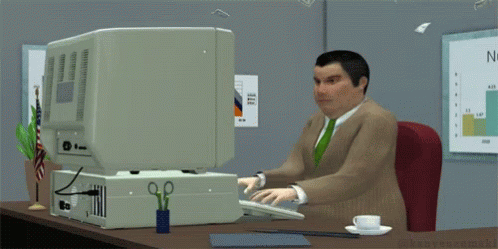 an animated man in a suit sitting at a computer