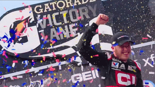 a man is holding his fist up in victory over confetti