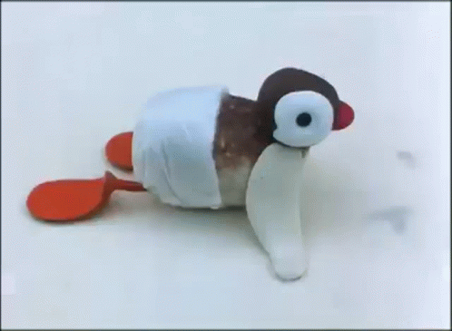 a black and white toy penguin with it's mouth open