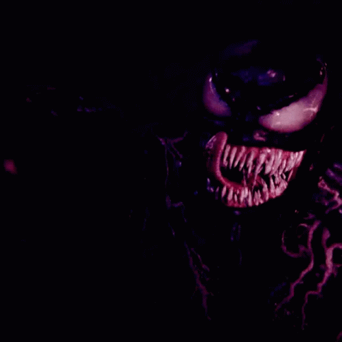 a close up of a clown's face in the dark