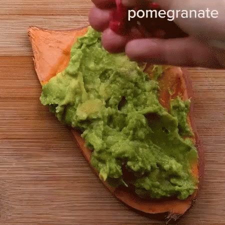 two hands are painting the green food