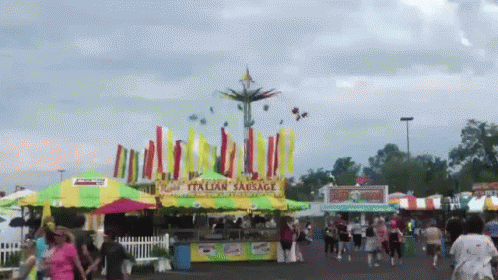 a group of people standing around a fair