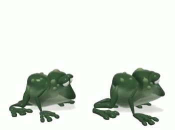 two plastic toy frog sitting next to each other