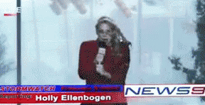 a news anchor holding a microphone on the street