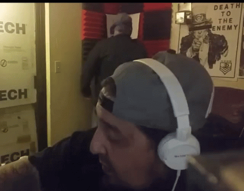 a man with headphones on his ears in a room