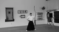 woman in white shirt and black skirt holding up a cane