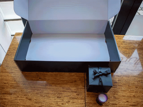 a box with the lid open on a blue carpet