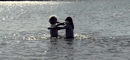 two people floating in the water near each other