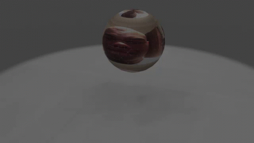 a sphere with a swirl design on it in the middle of a light room