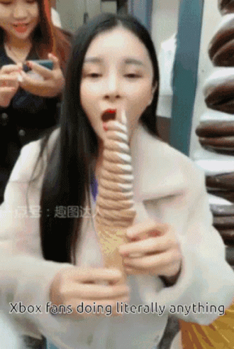 there are two women that have a giant toothbrush
