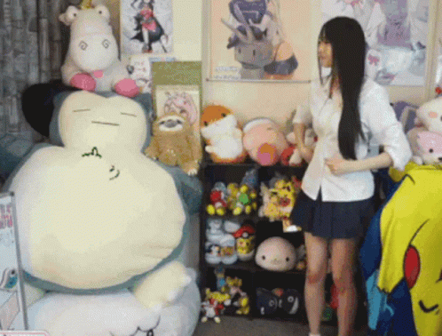 a woman standing in a room surrounded by stuffed animals