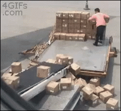 the men are in a warehouse and they are in the process of transporting the boxes