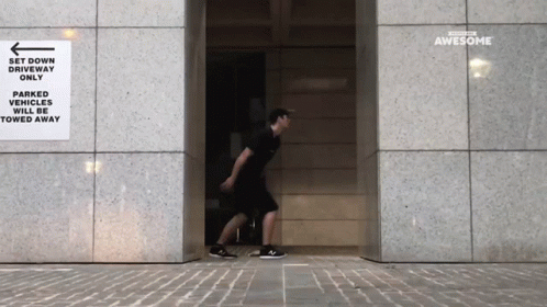 a man leaving an entrance to an office building