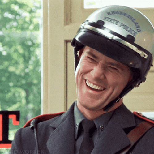 a guy wearing a helmet smiling at the camera