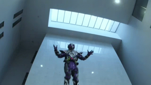 a sci - fiist dressed in all purple and holding his arms out while standing inside a building