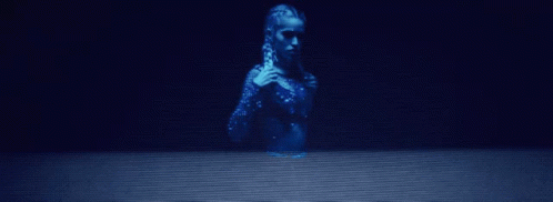 a statue sits alone in the dark of night