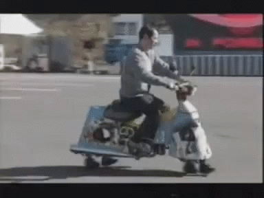 a man riding on the back of a motorized scooter