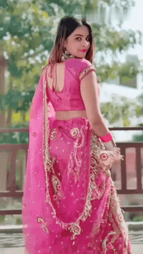 a woman in a purple sari posing for a po