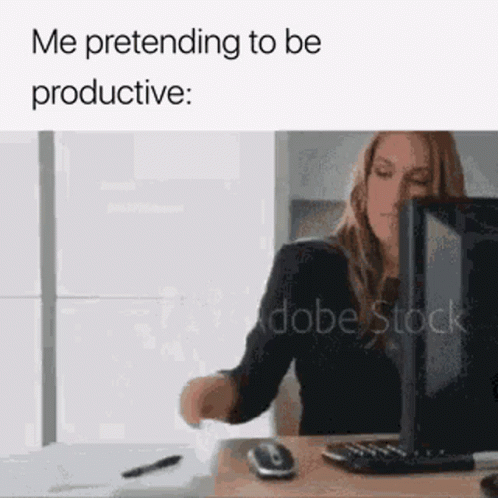 a woman sitting in front of a computer with the caption me pretending to be productive