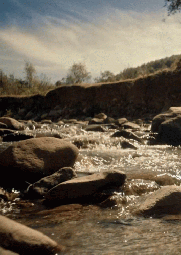 water flowing between rocks in stream of stream