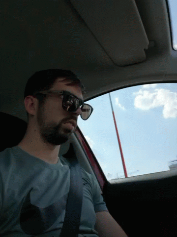 man in sunglasses sitting in a car