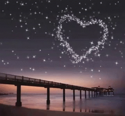 a bridge over a body of water and stars