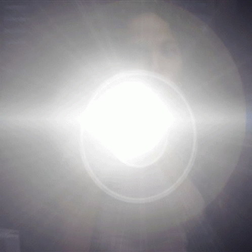 the sun shining in the sky through it's white lens