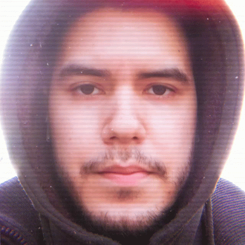 a man is looking into the camera while wearing a hoodie