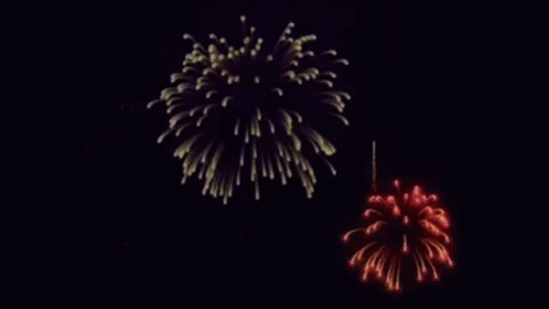 two colored fireworks against a black background