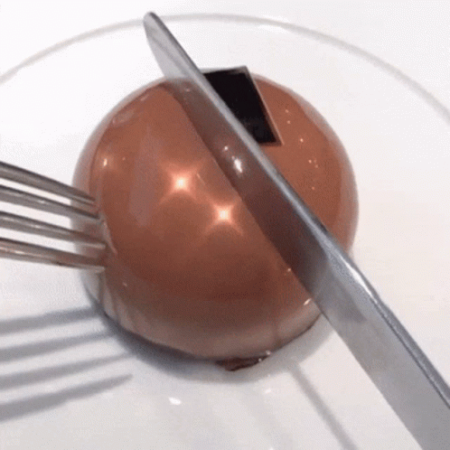 a blue ball and metal fork on top of it