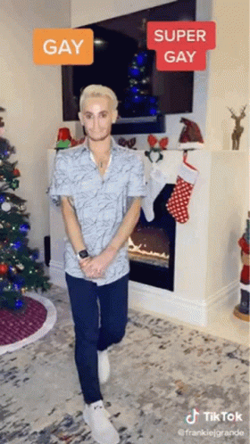 a person with fake clothes is standing in front of a christmas tree