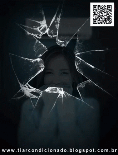 a woman is shown through a smashed up window