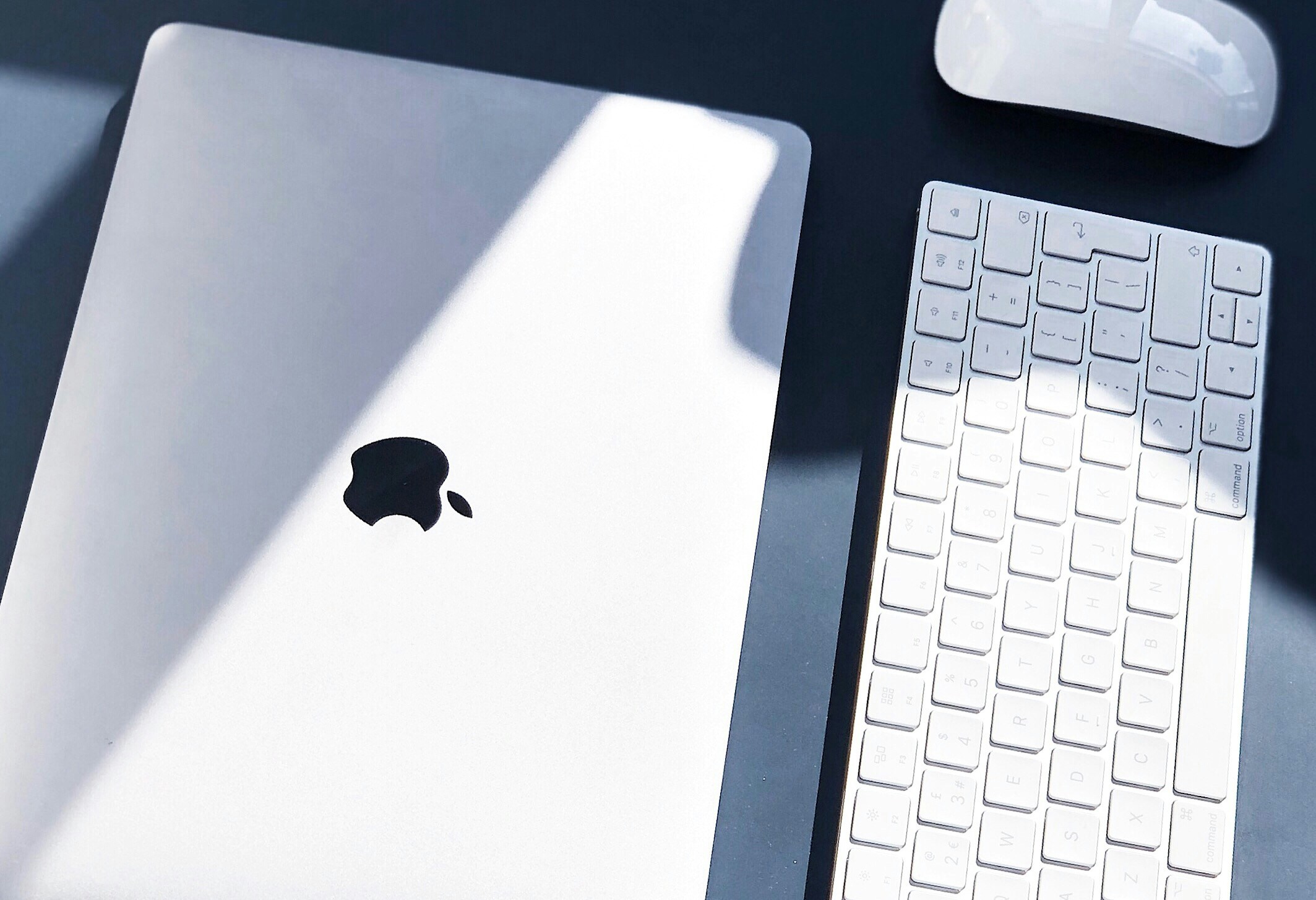 an apple keyboard sitting next to an ipad