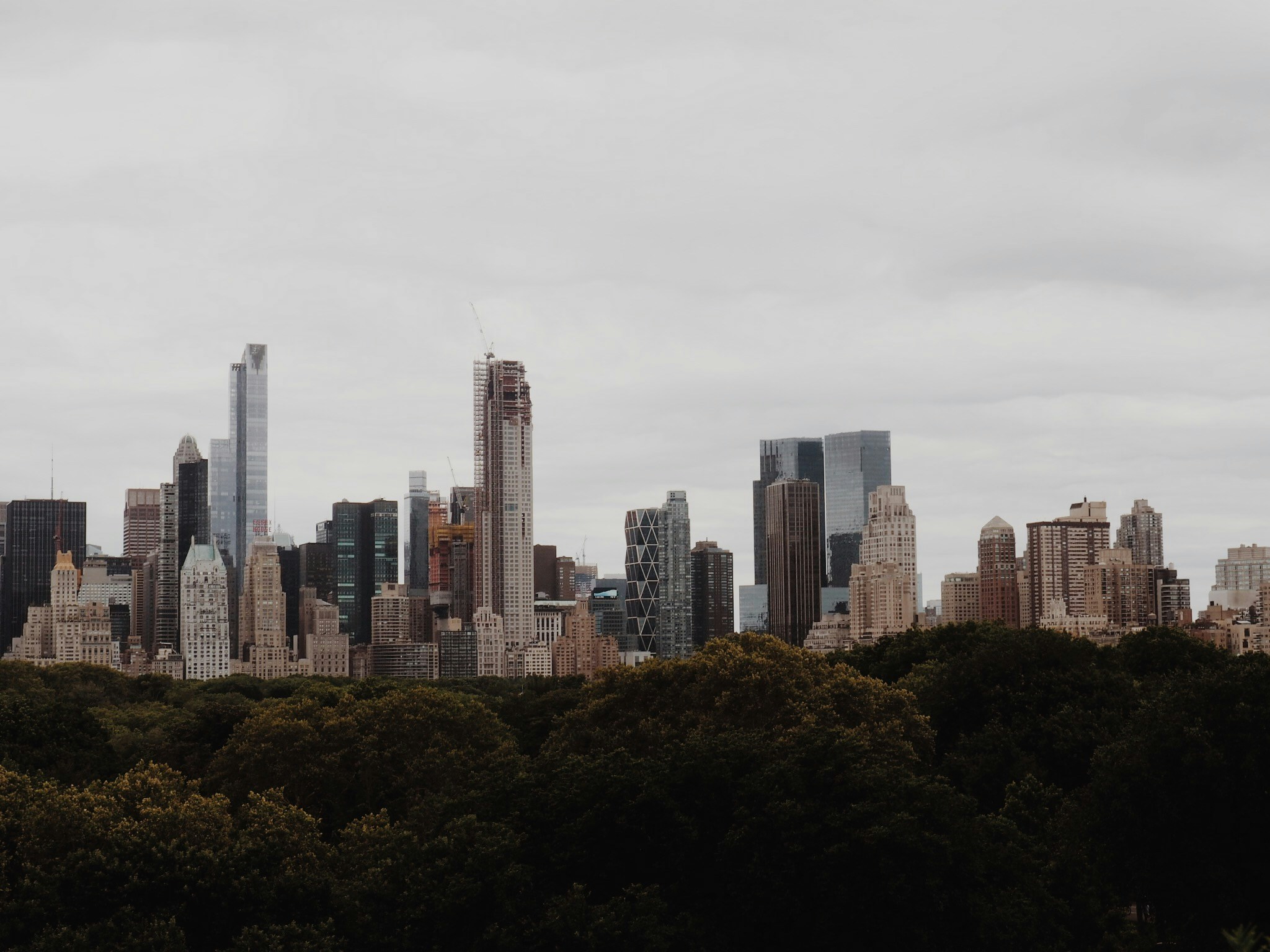 the tall skyscrs of new york city with clouds in the background