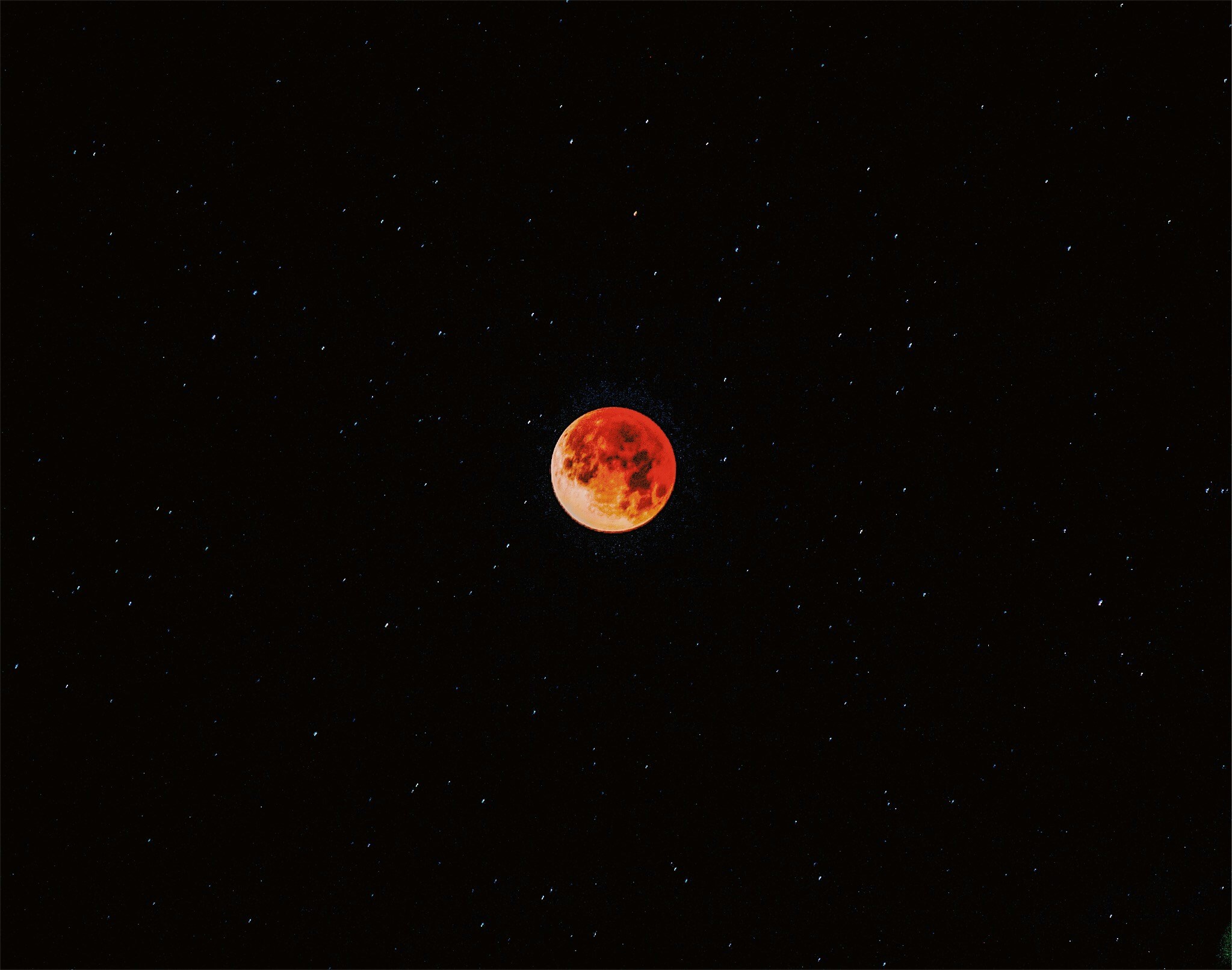 there is a red and black moon in the dark night sky