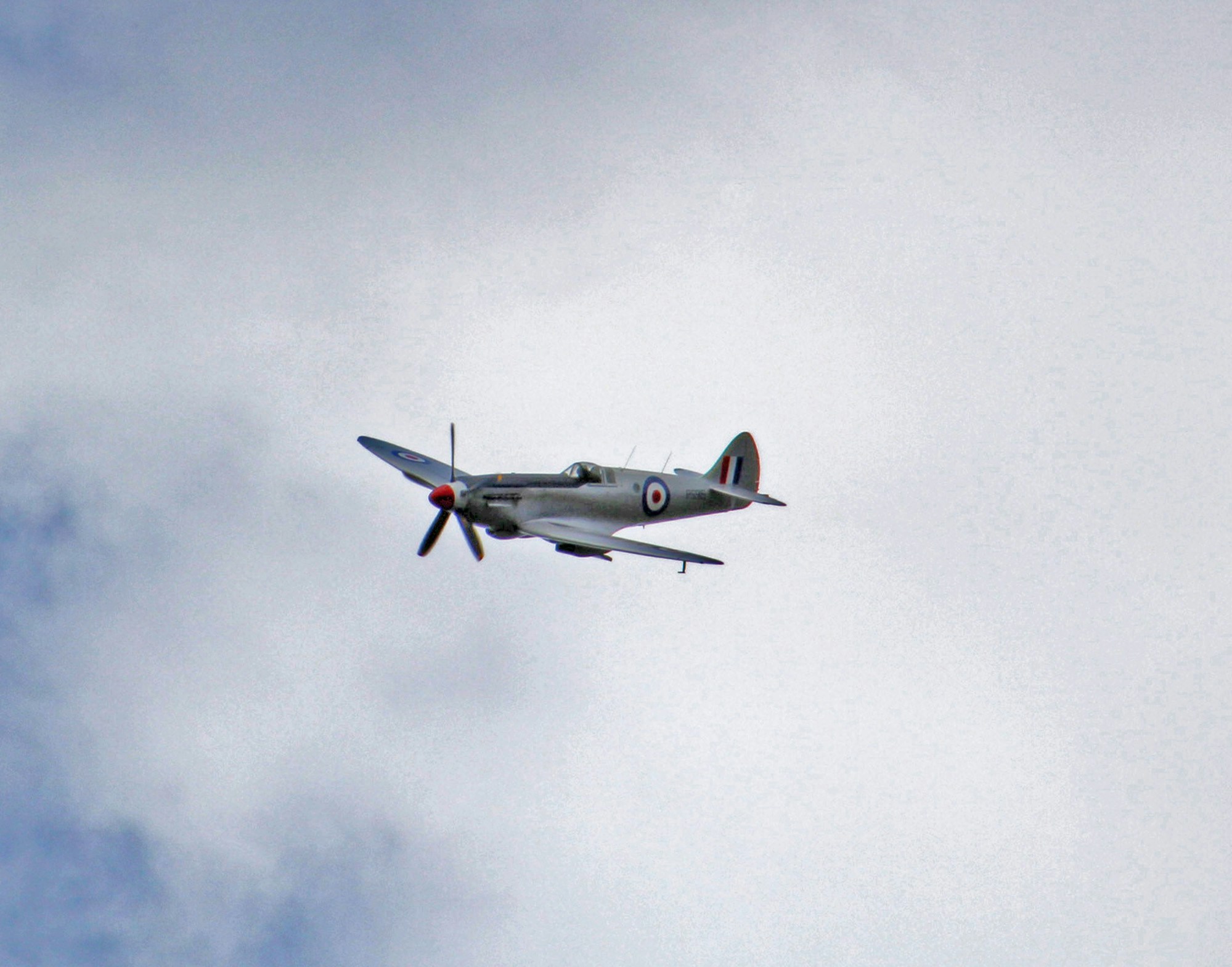 an airplane is flying through the sky with clouds