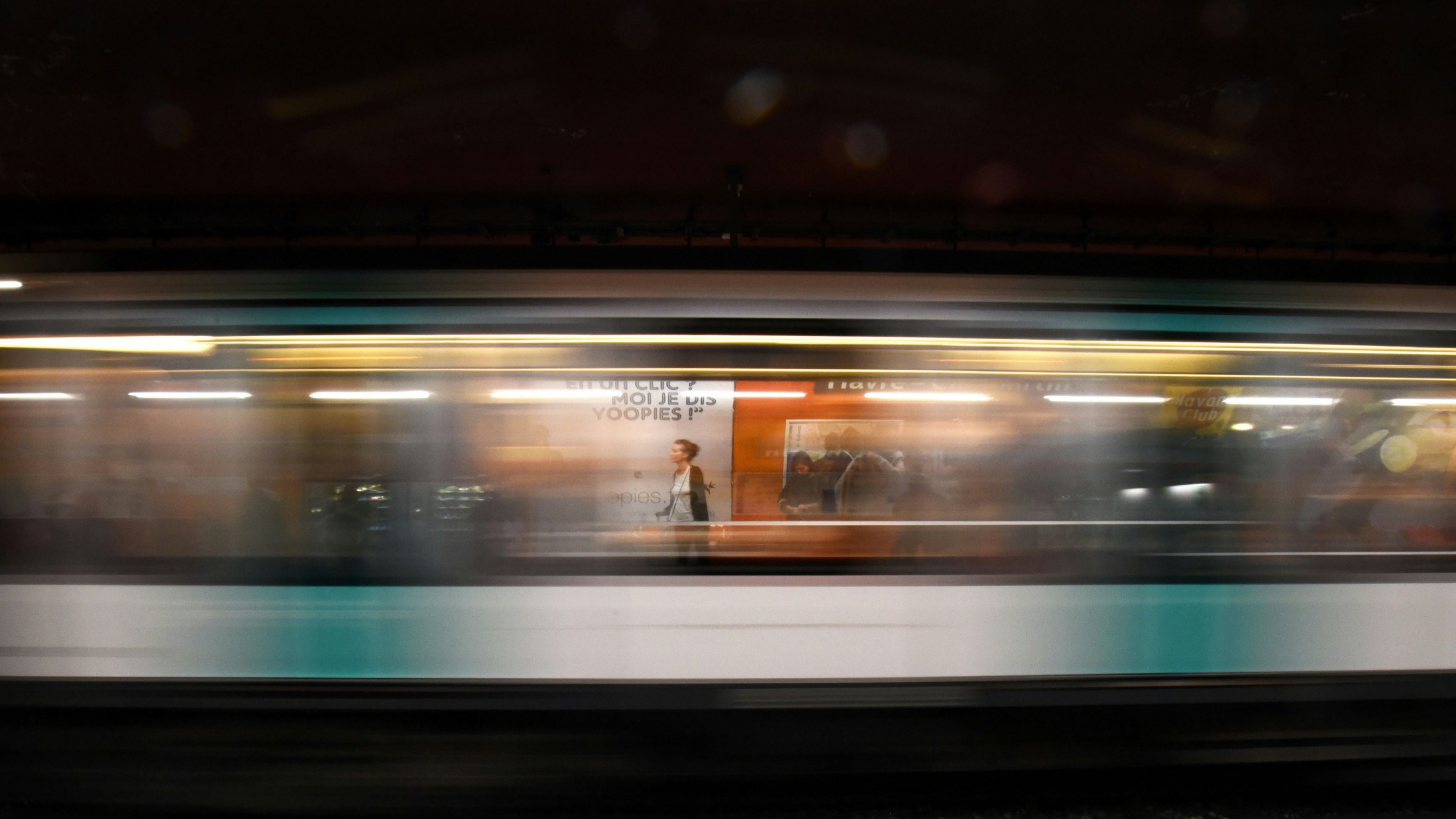 a blurry image of a train's speed by on the tracks