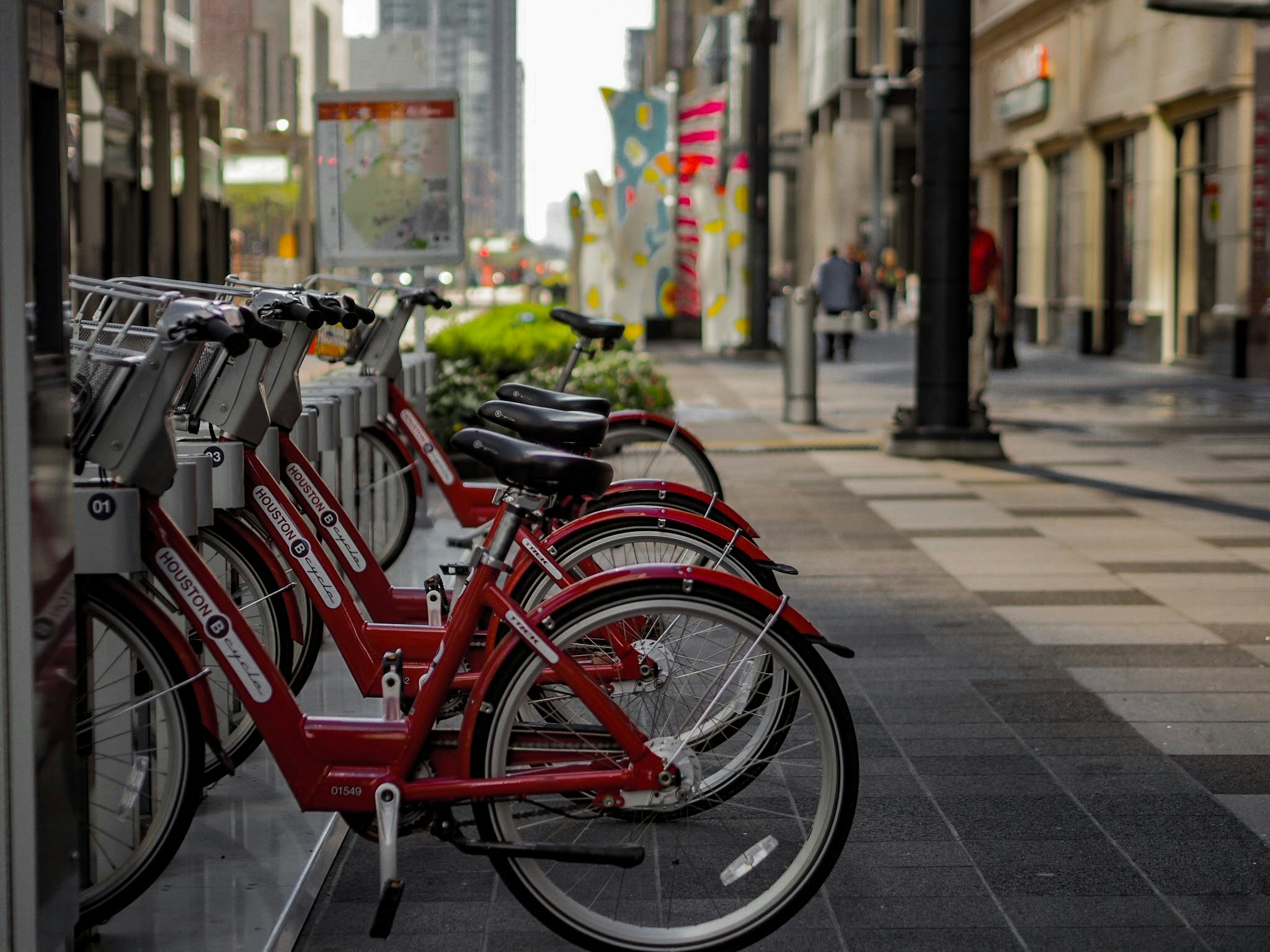 a row of bicycles parked next to each other in front of buildings