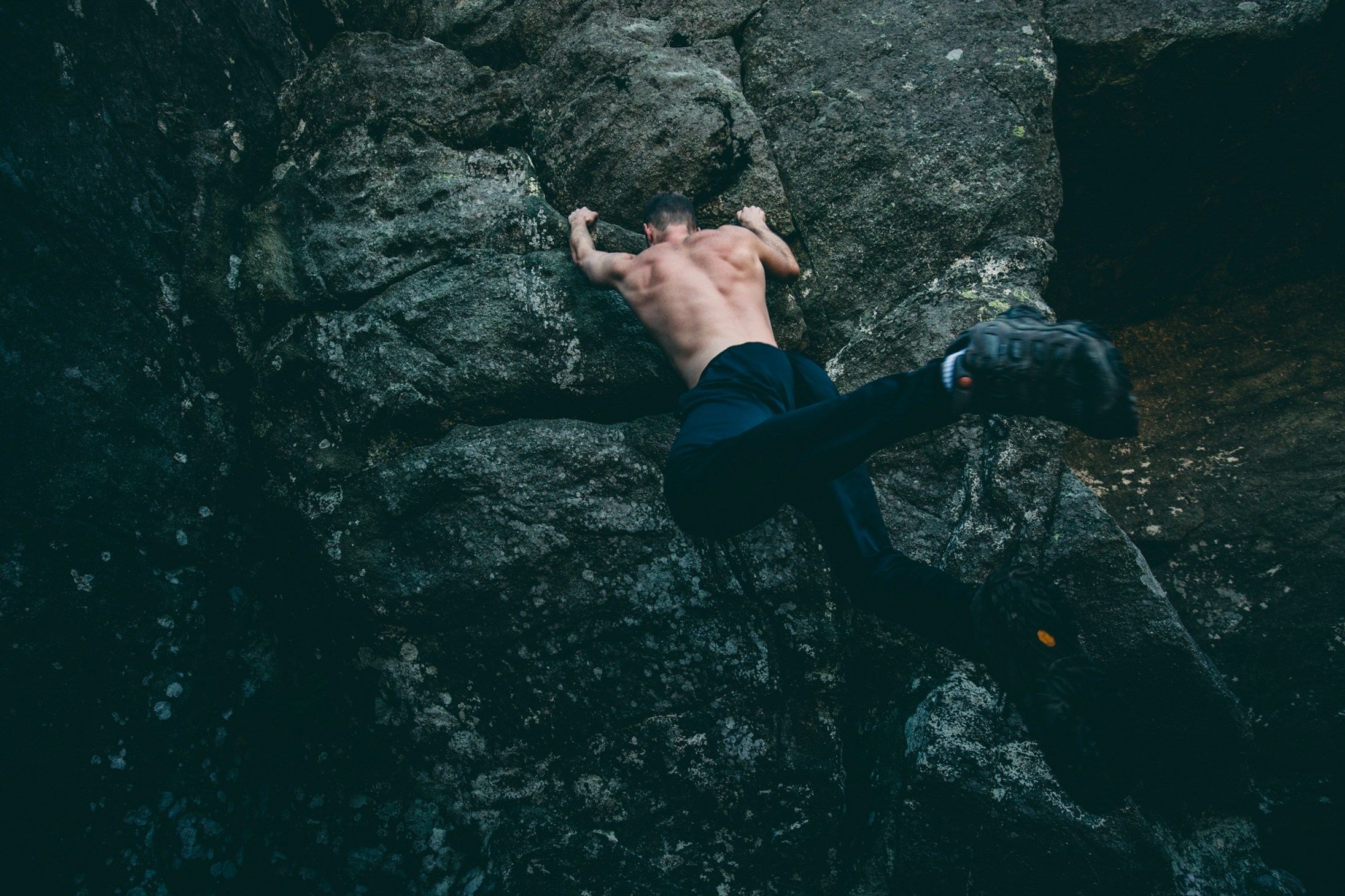 a man climbing up the side of a cliff