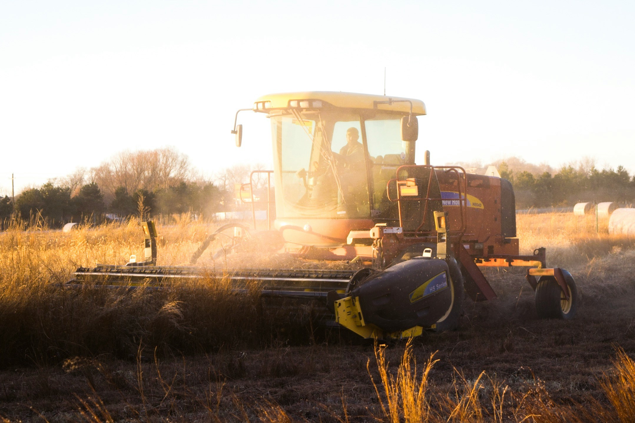 a tractor that is working on some grass