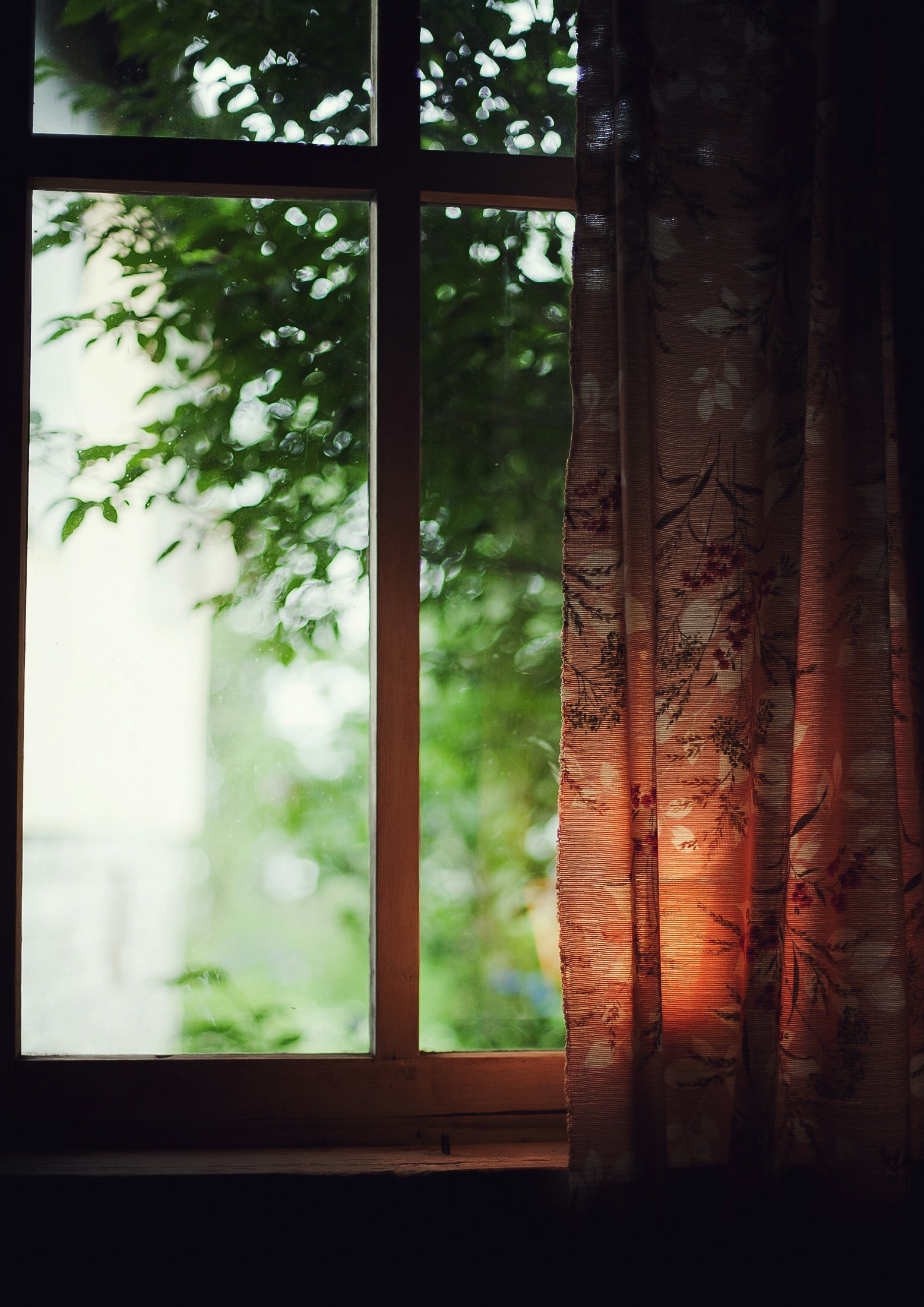 sunlight shining through a window at dusk on a curtain