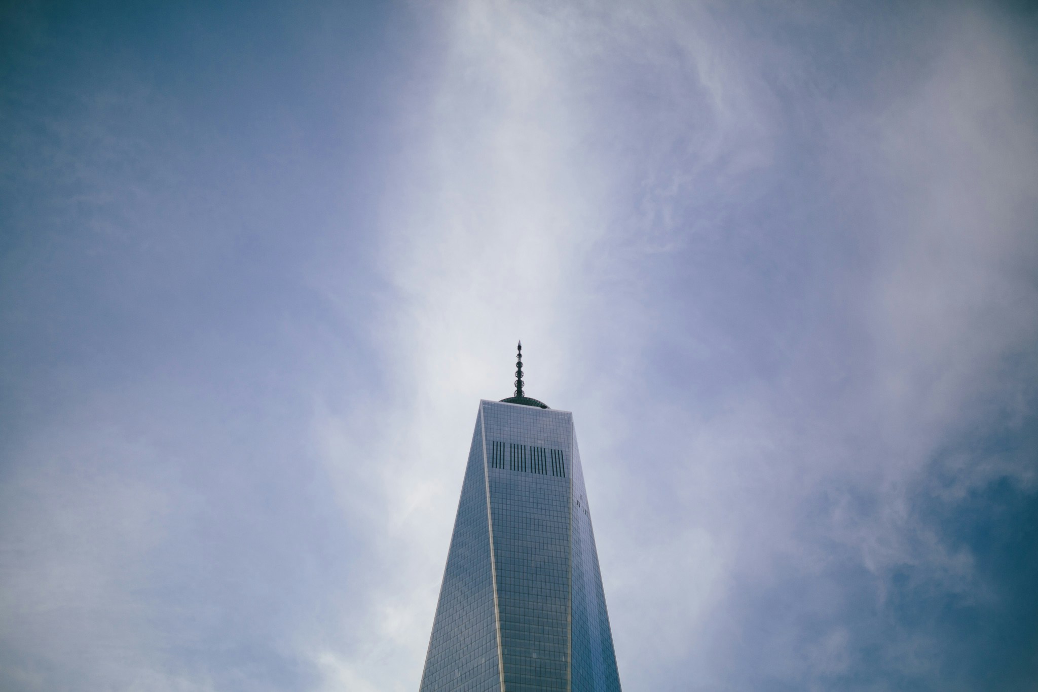 the top of a tall tower with a clock on it's side