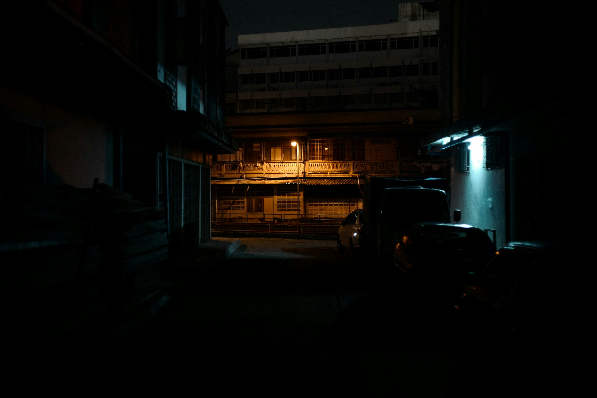dark scene with a street sign lit up in front