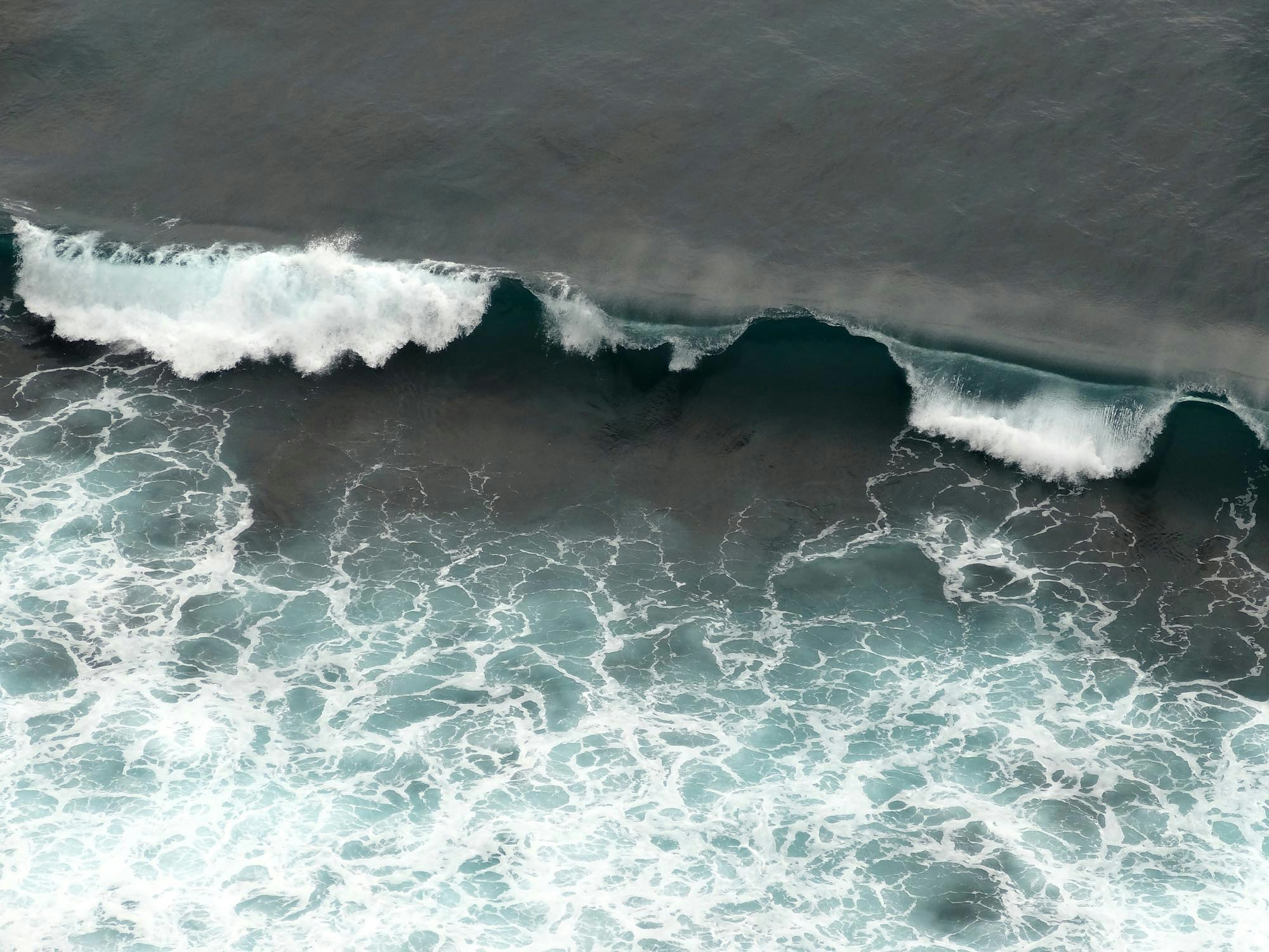 an overhead view of waves in the ocean