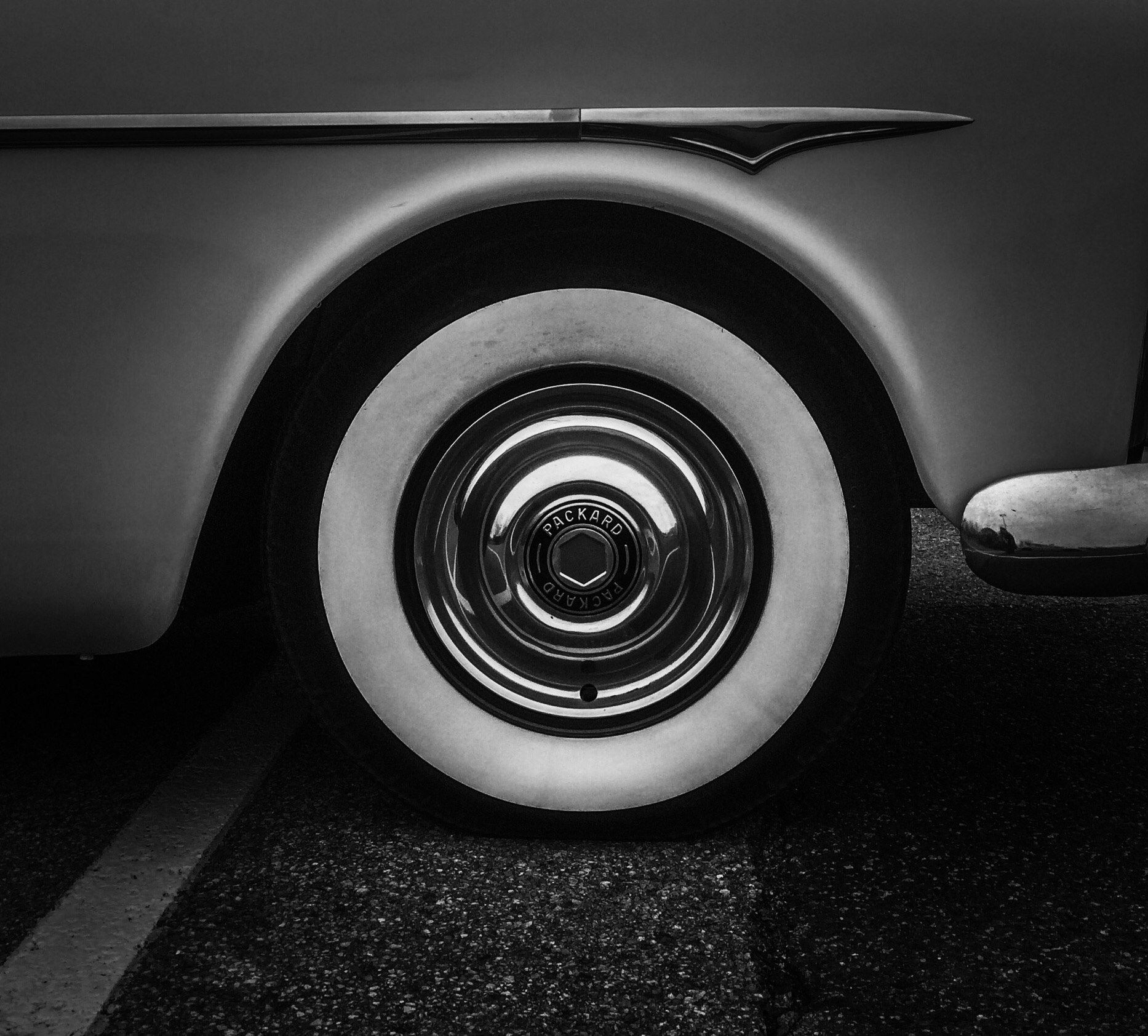 an antique white car is pographed in the dark